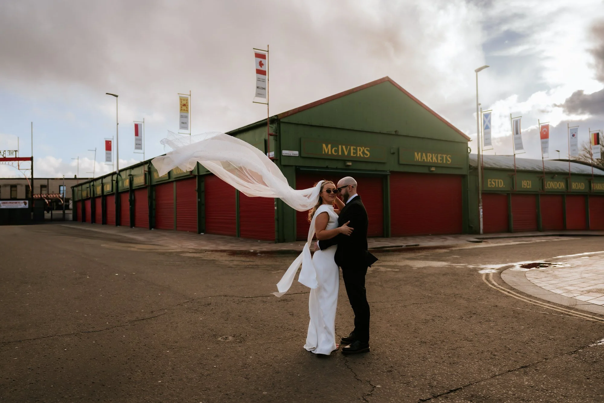 Rhona and Ciaran beneath her flowing veil outside the McIver's building in the Barras.