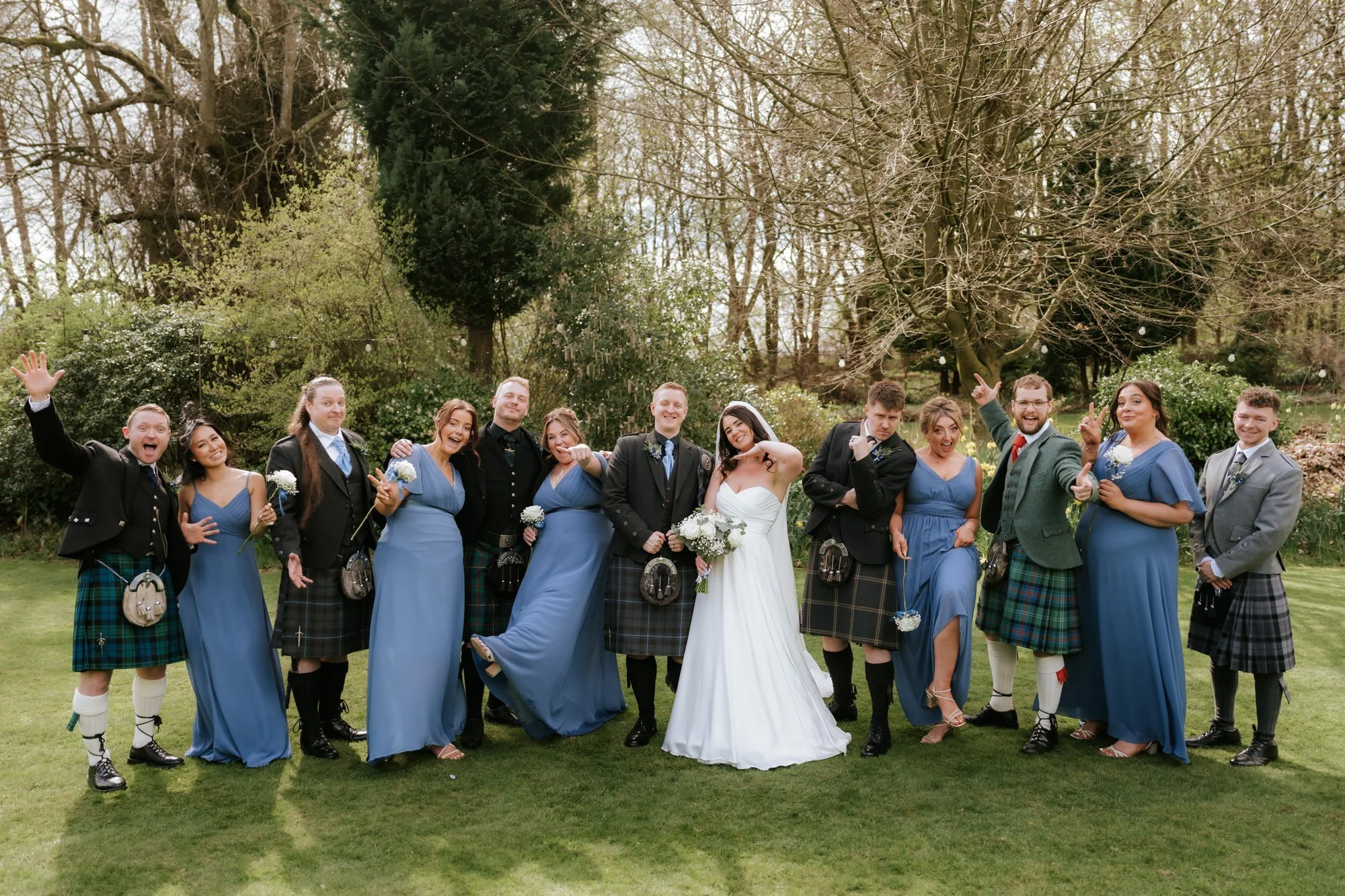 The wedding party cheering together at Balbirnie House.