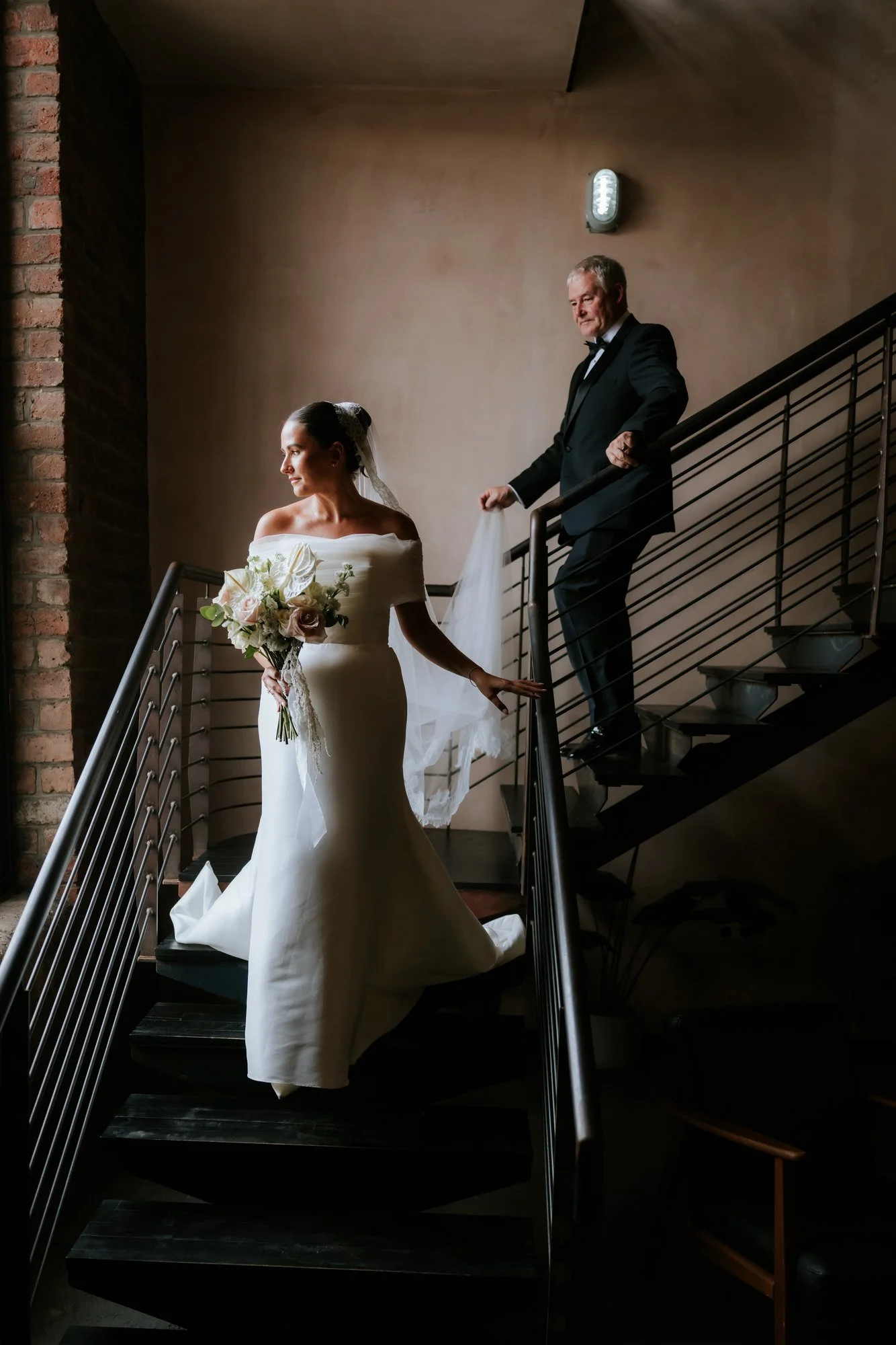 Caitlin walking down the staircase before her ceremony.