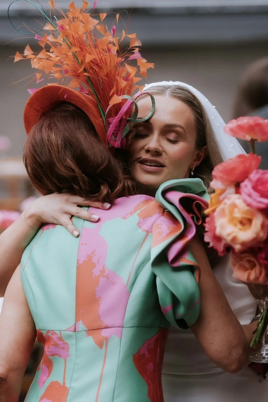 Rhona greeting a guest with a hug after the ceremony.