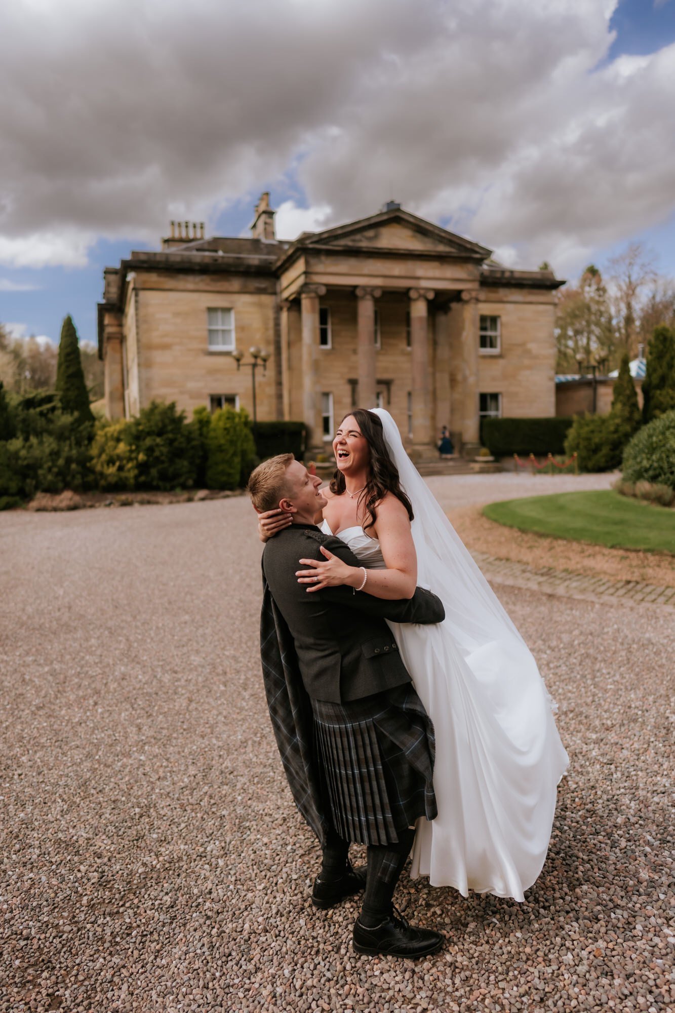 Calum lifting Steph outside Balbirnie House.