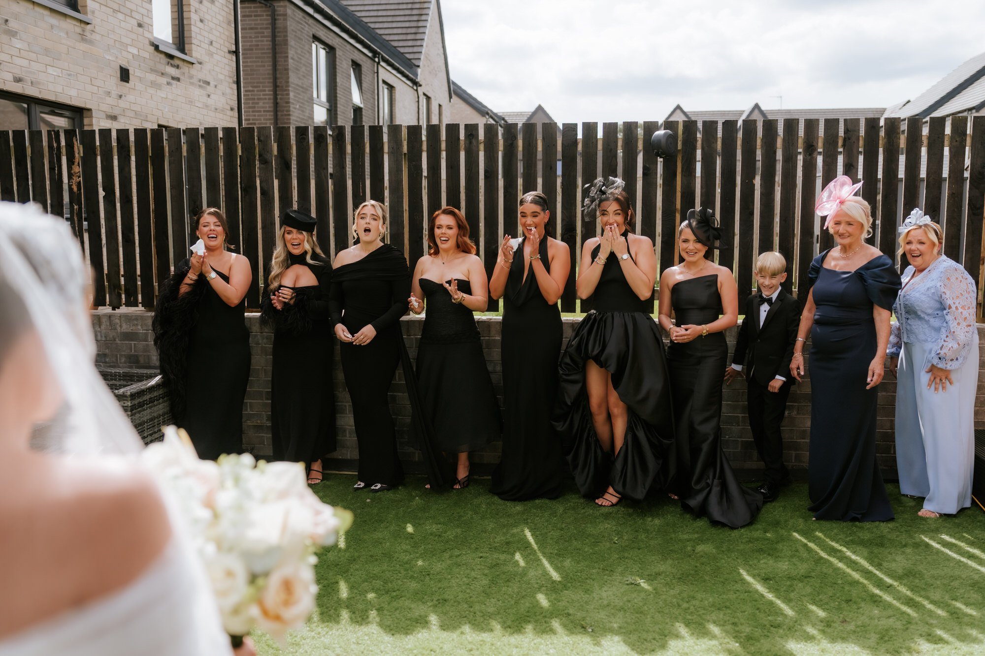 Friends and family reacting as they see Caitlin in her wedding dress.