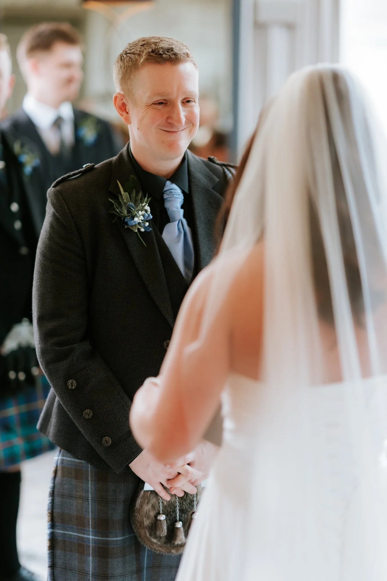 Calum smiling towards Steph during the vows.