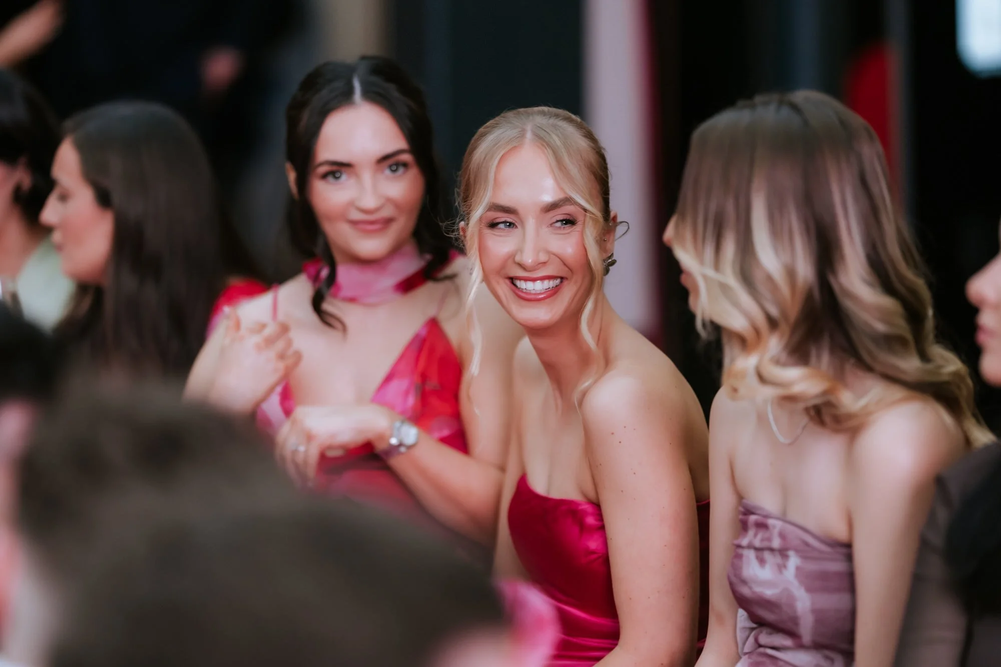A bridesmaid laughing during the wedding reception.
