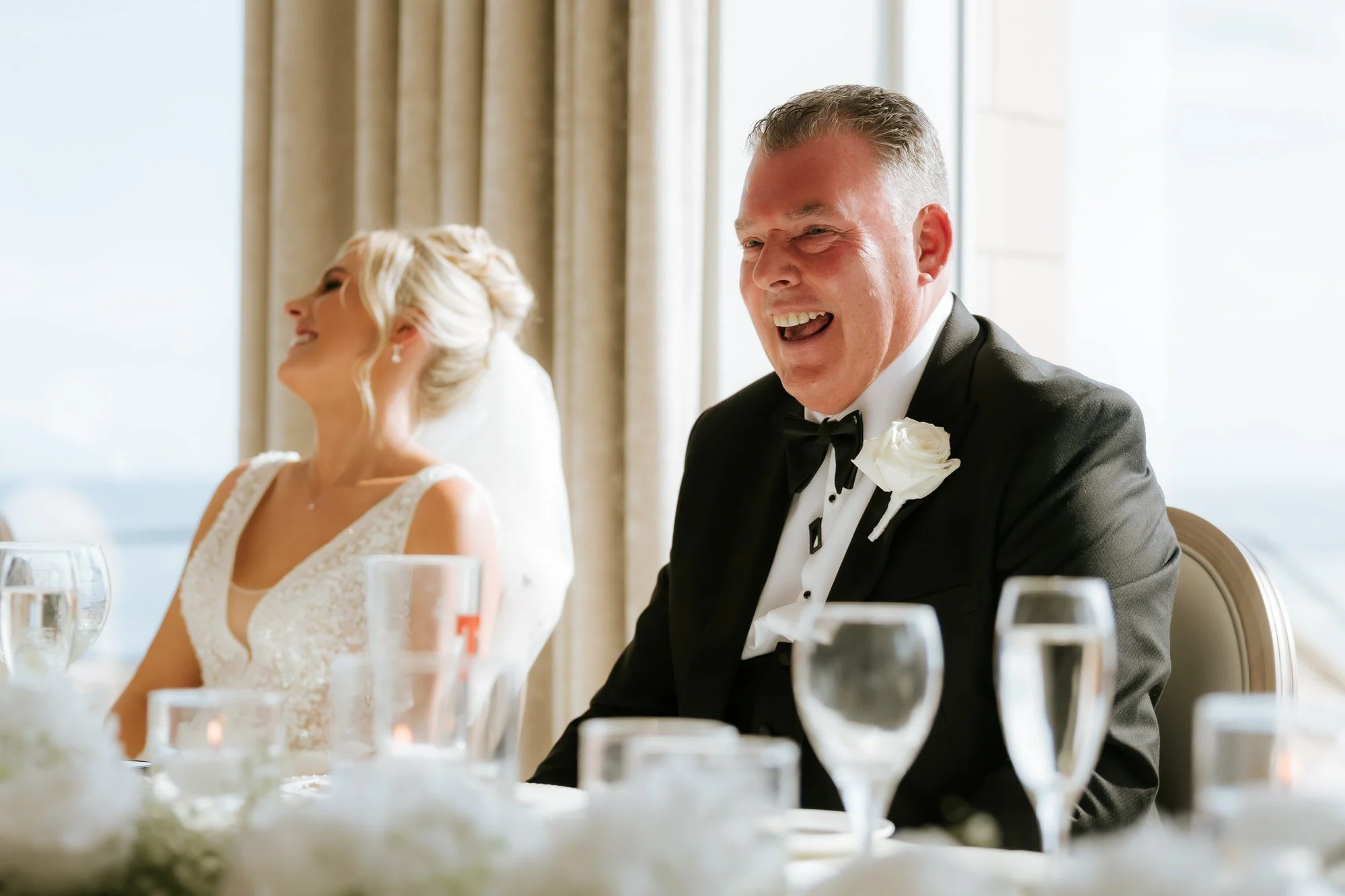 Nicole and her dad laughing at the top table.