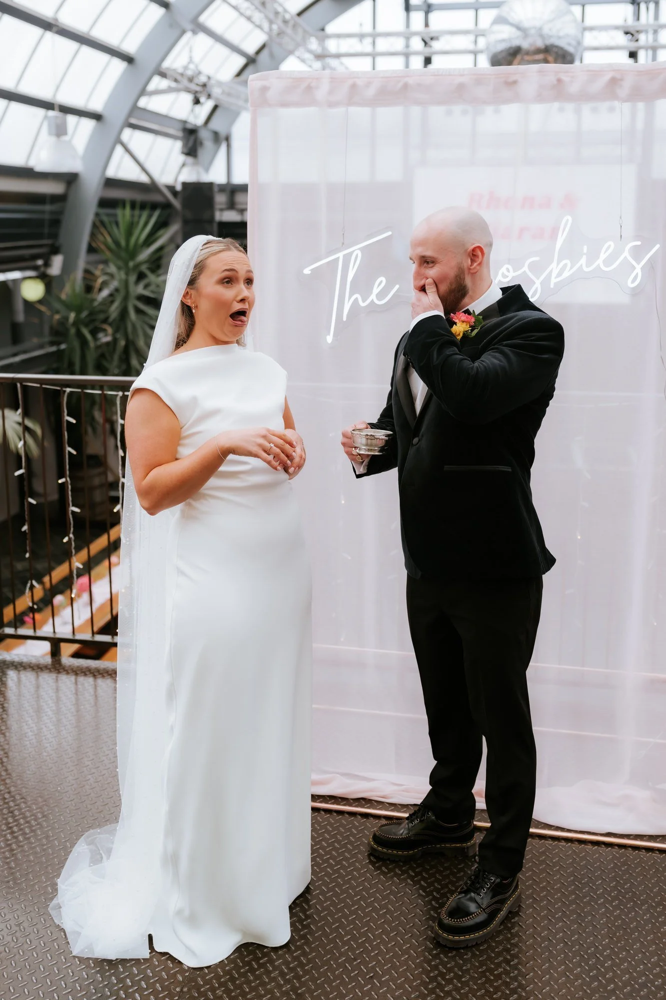 The couple laughing during the quaich ceremony.