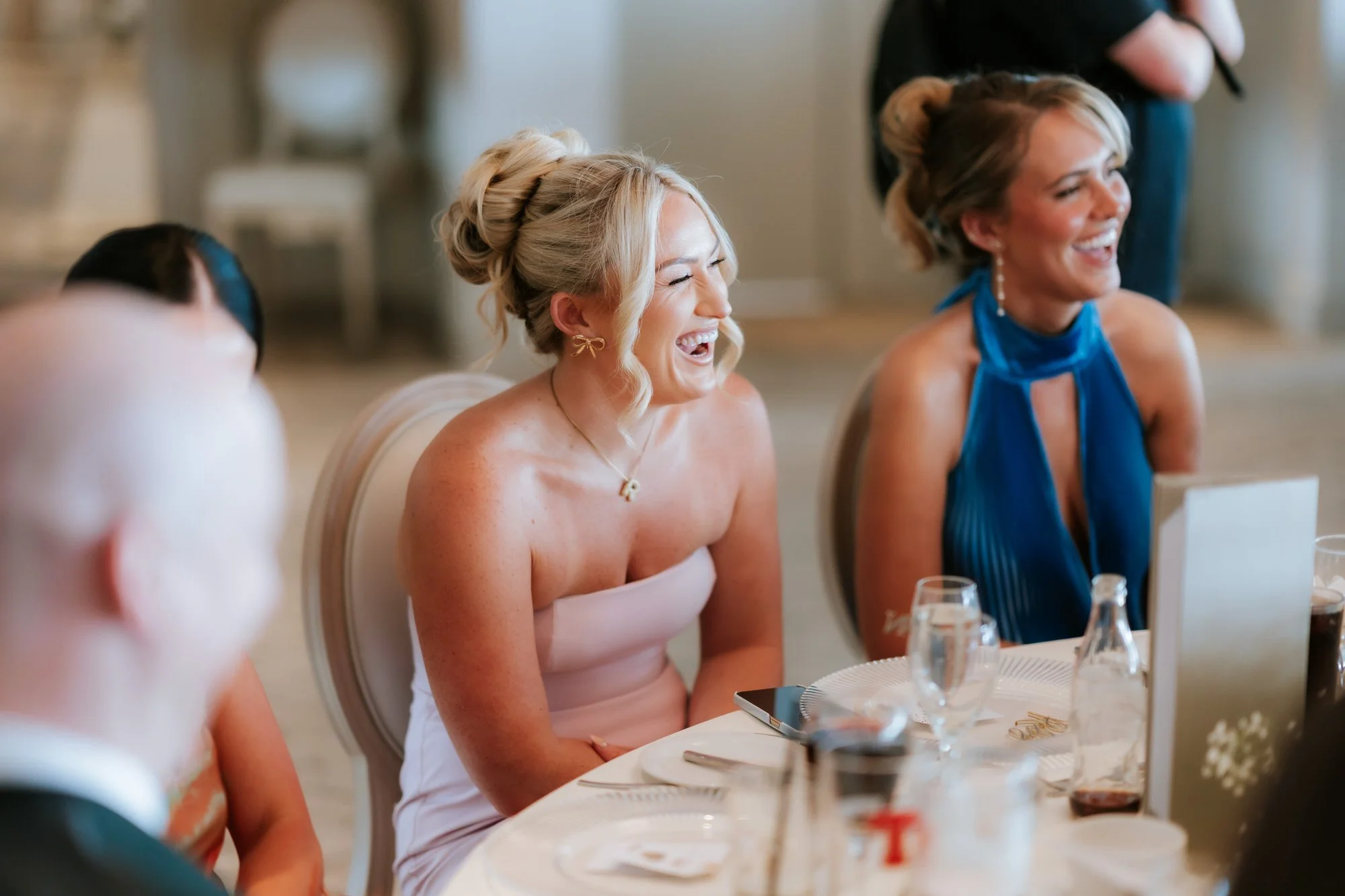 Two guests enjoying a laugh during the reception.
