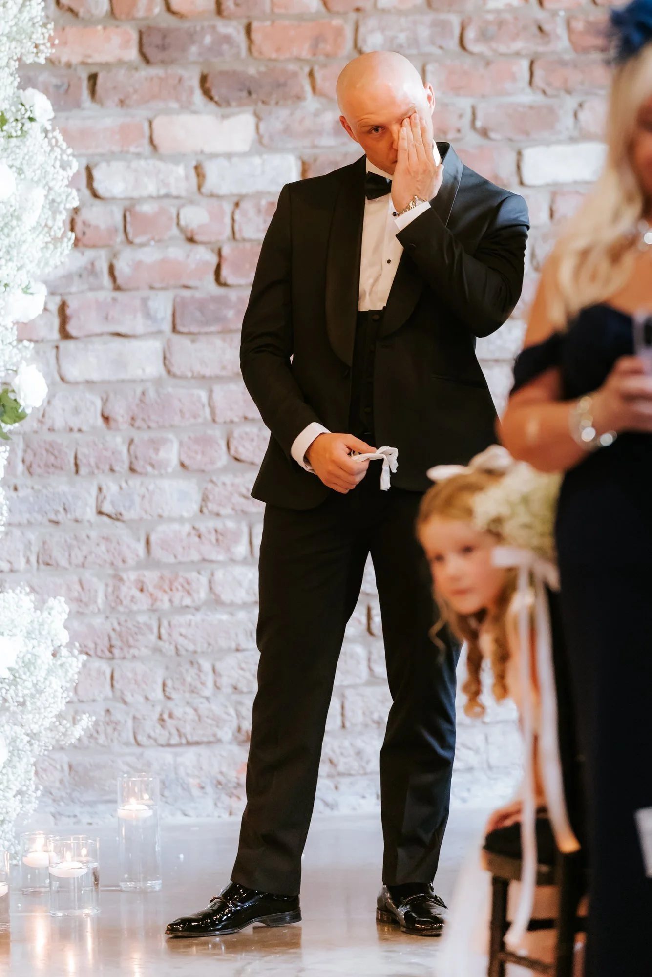 Craig wiping away a tear during the wedding ceremony.