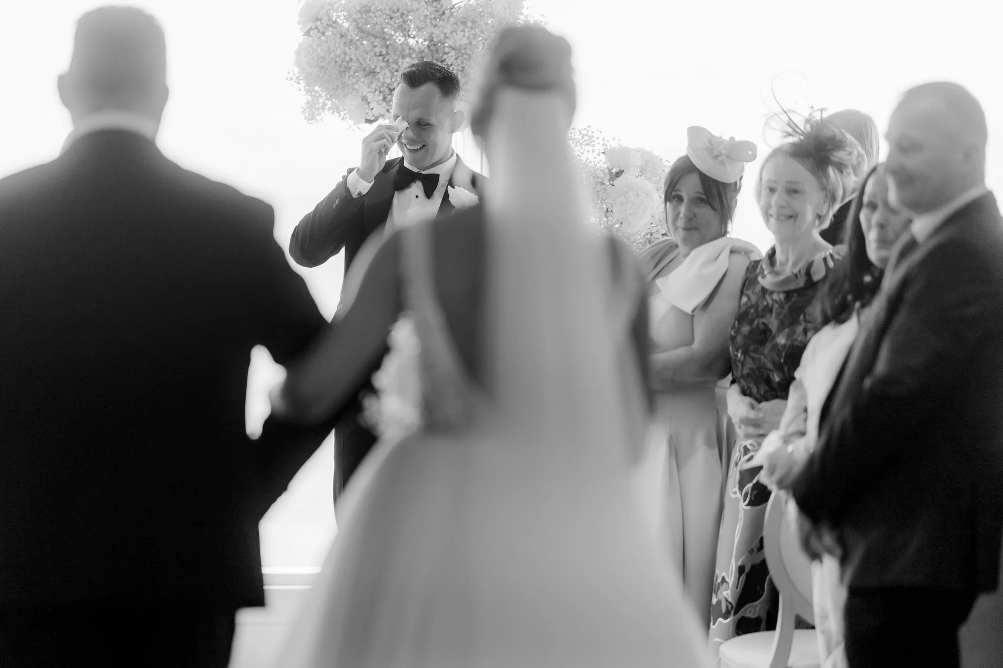 Lawrence wiping away a tear as Nicole arrives for the ceremony.