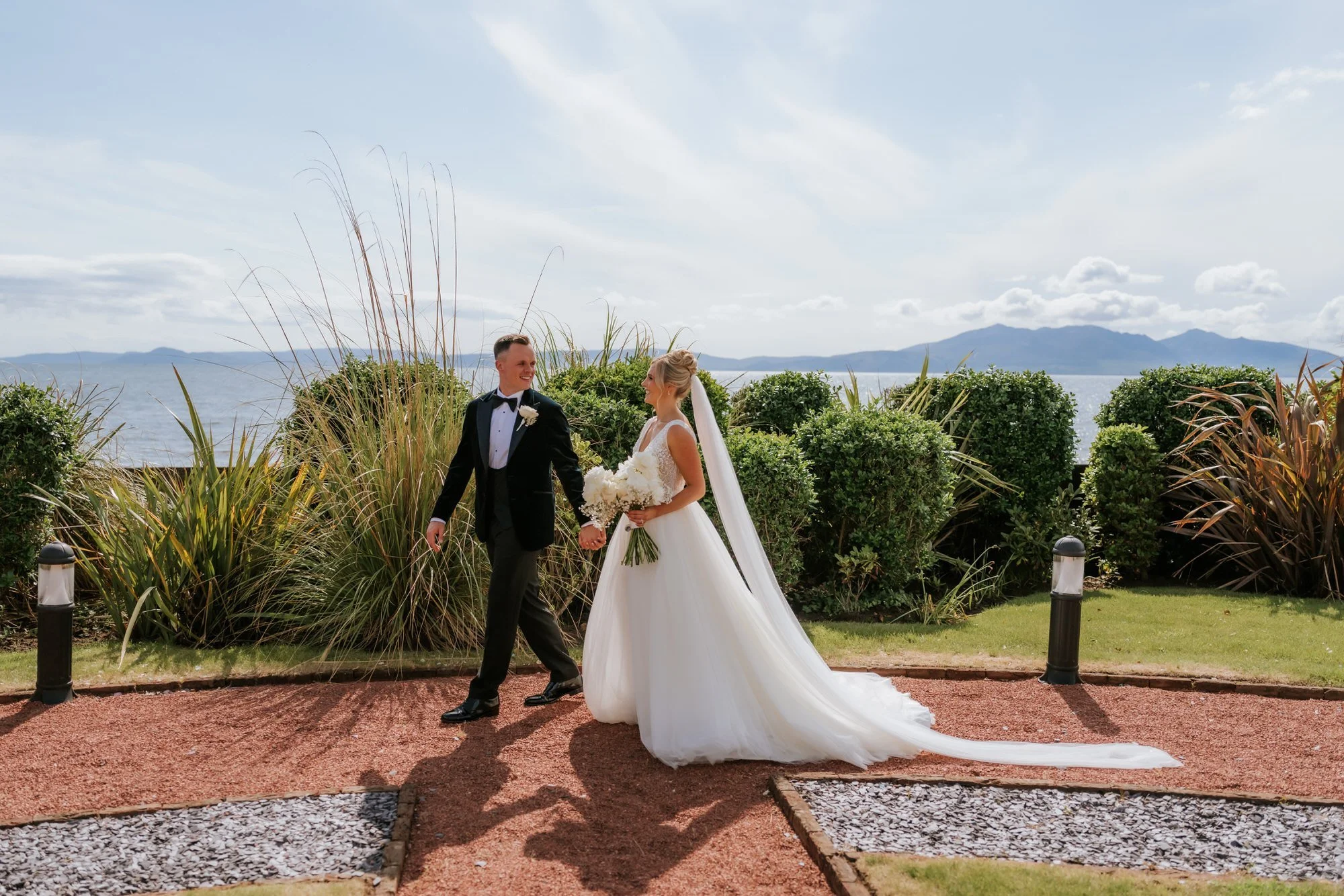 Nicole and Lawrence walking along a garden path at Seamill Hydro.