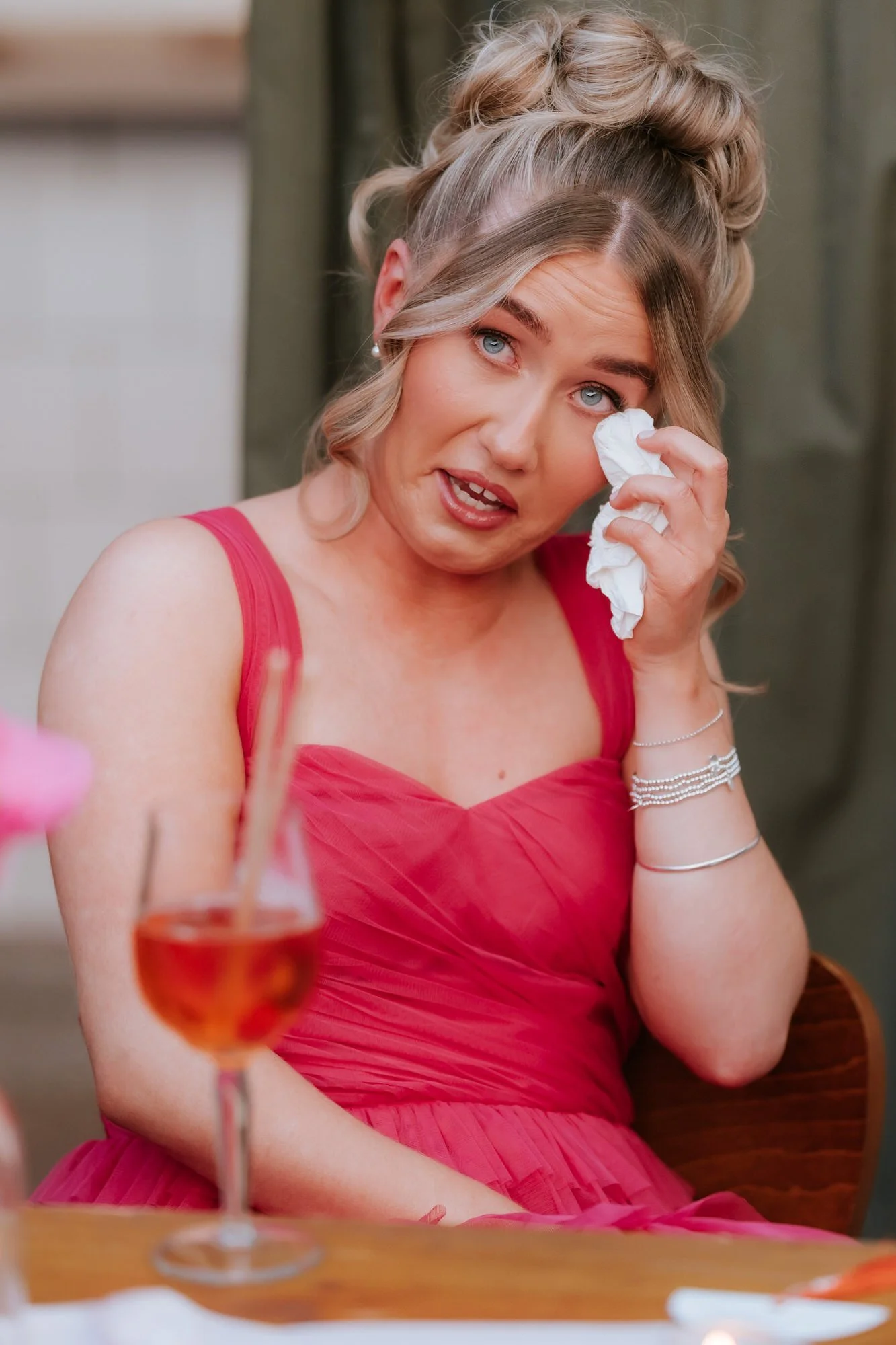 A bridesmaid wiping away a happy tear.