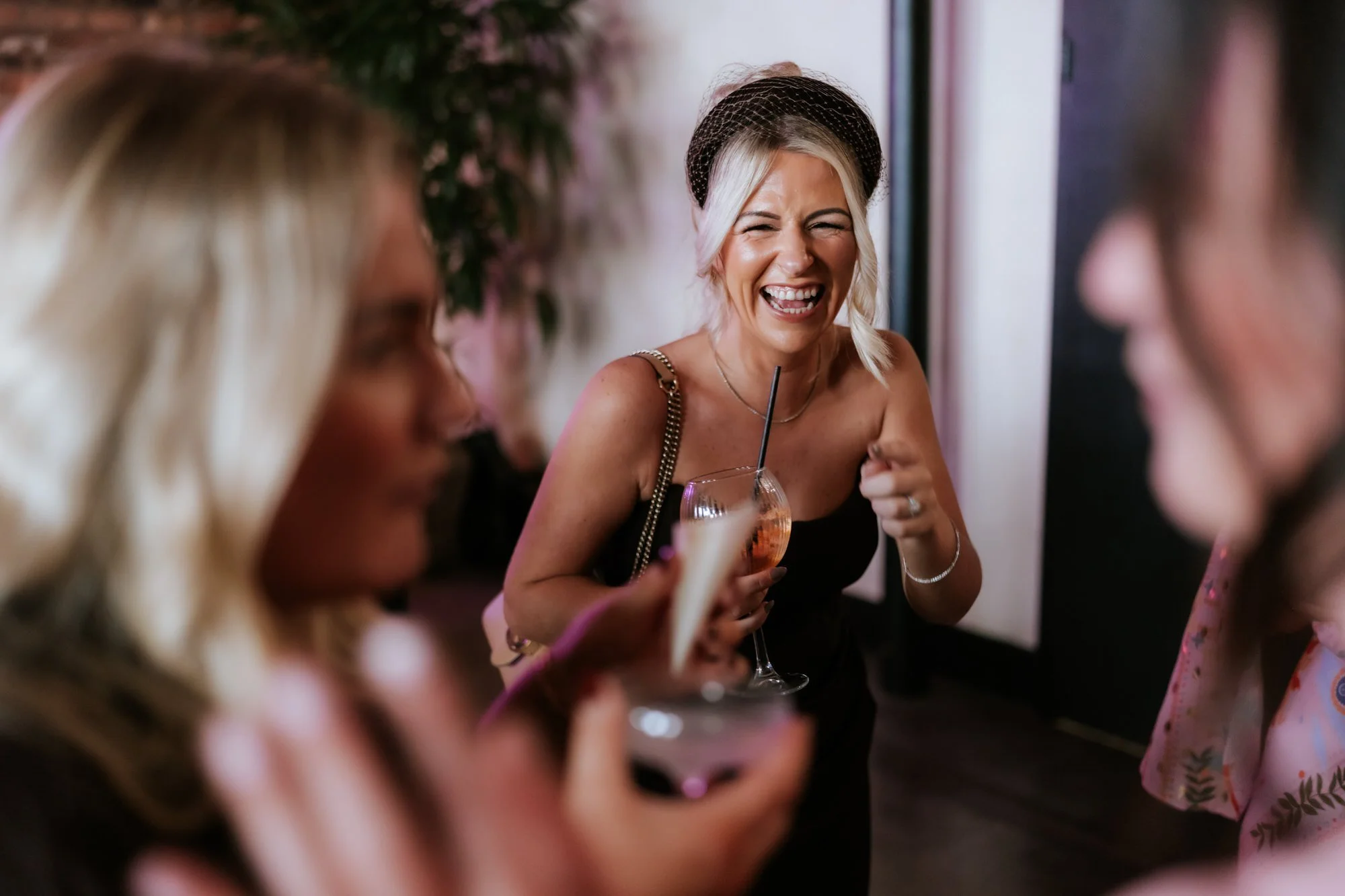 A wedding guest laughing during the reception.