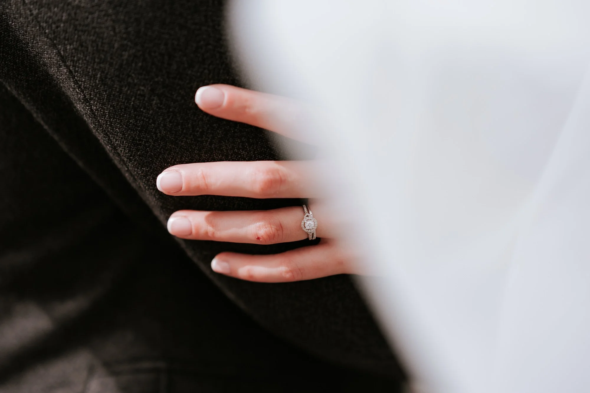 A close photograph of the couple's hands and wedding rings.