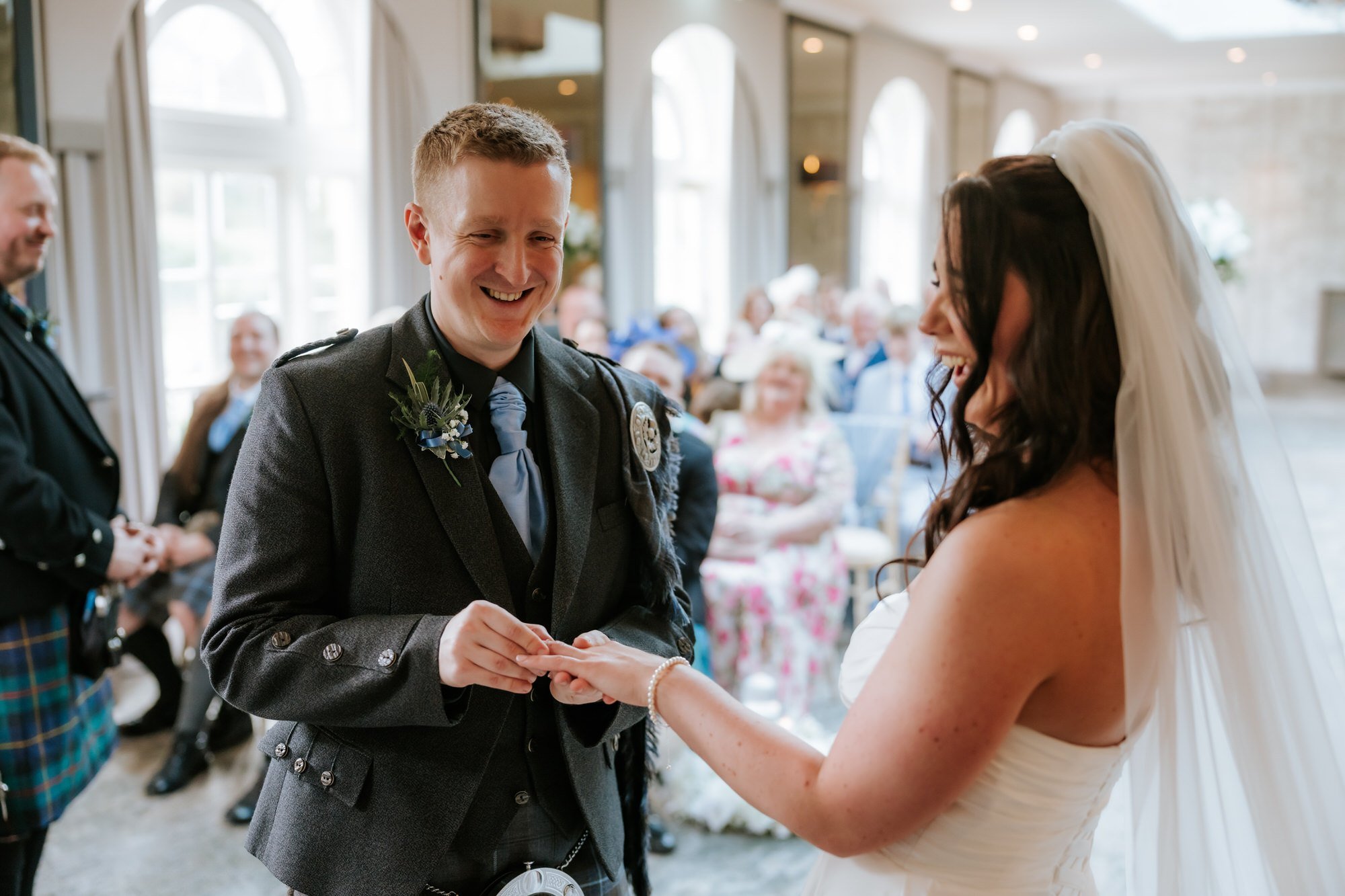 Calum receiving his wedding ring during the ceremony.