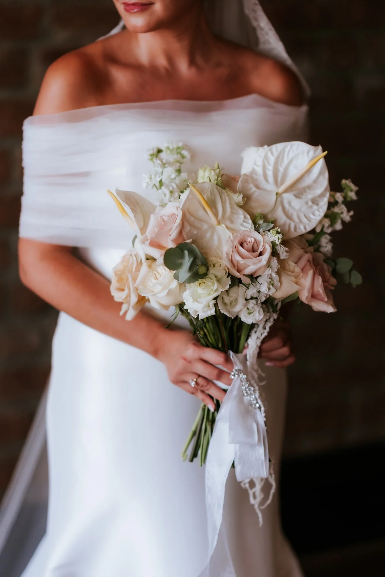Caitlin's bouquet with white anthuriums and pale roses.