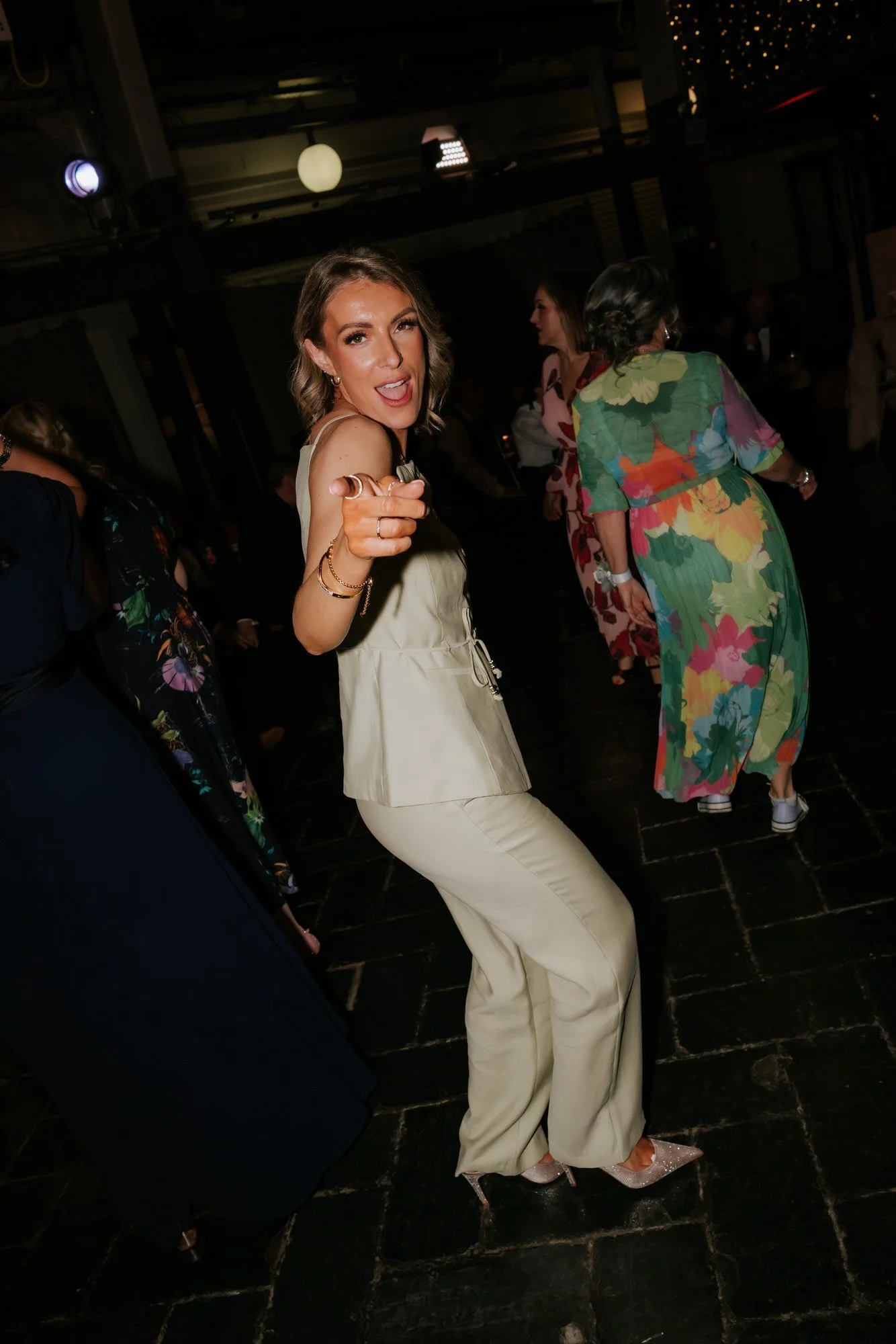 A guest dancing and pointing towards the camera.