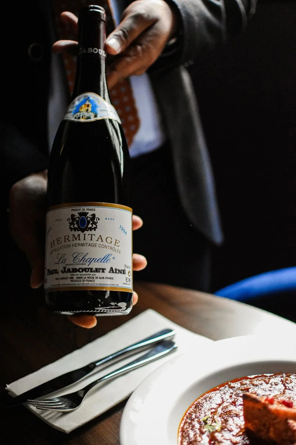 A bottle of Paul Jaboulet Aine La Chapelle Hermitage 1994 presented at the table