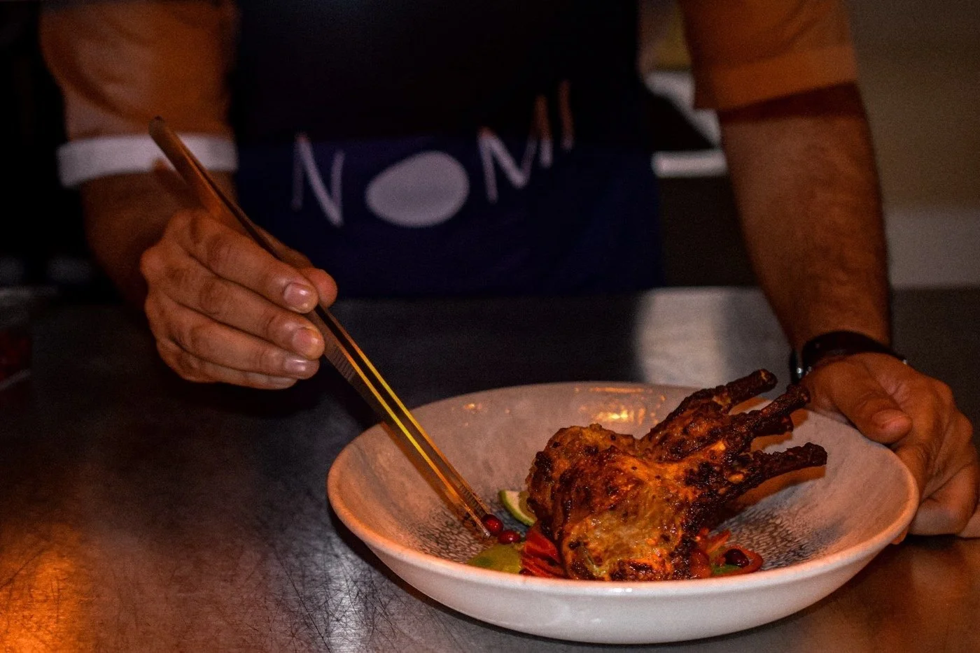 Plating lamb chops at the pass