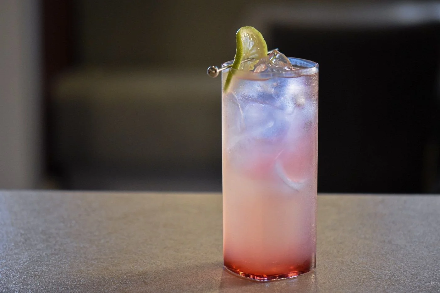 A pink highball with lime