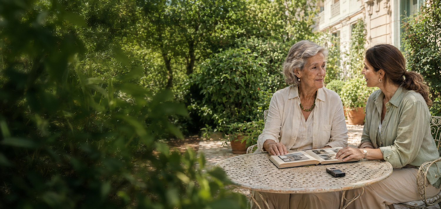 Una mujer mayor conversa con una profesional de memoria en un jardín