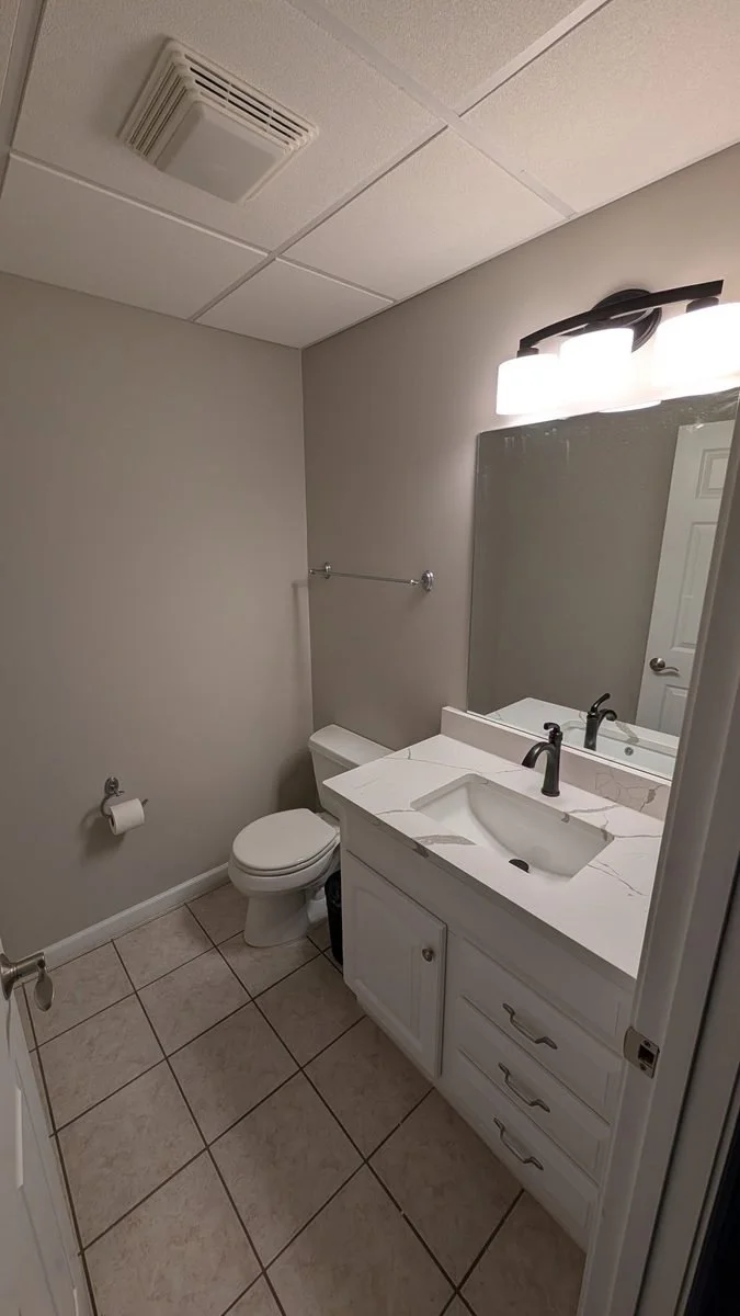 Bathroom vanity with mirror and light fixture