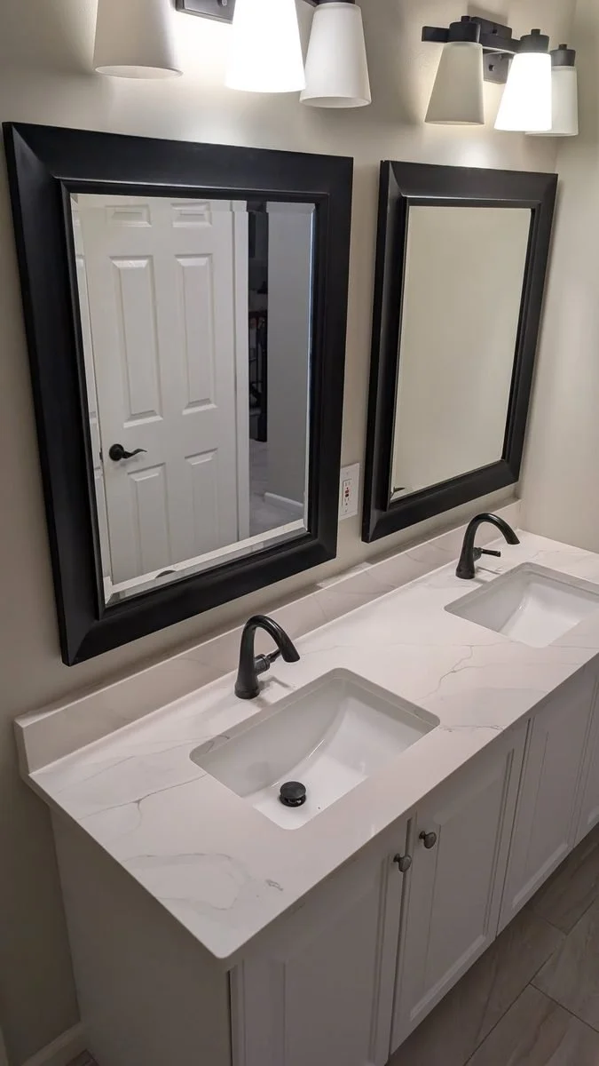 Double bathroom vanity with black-framed mirrors