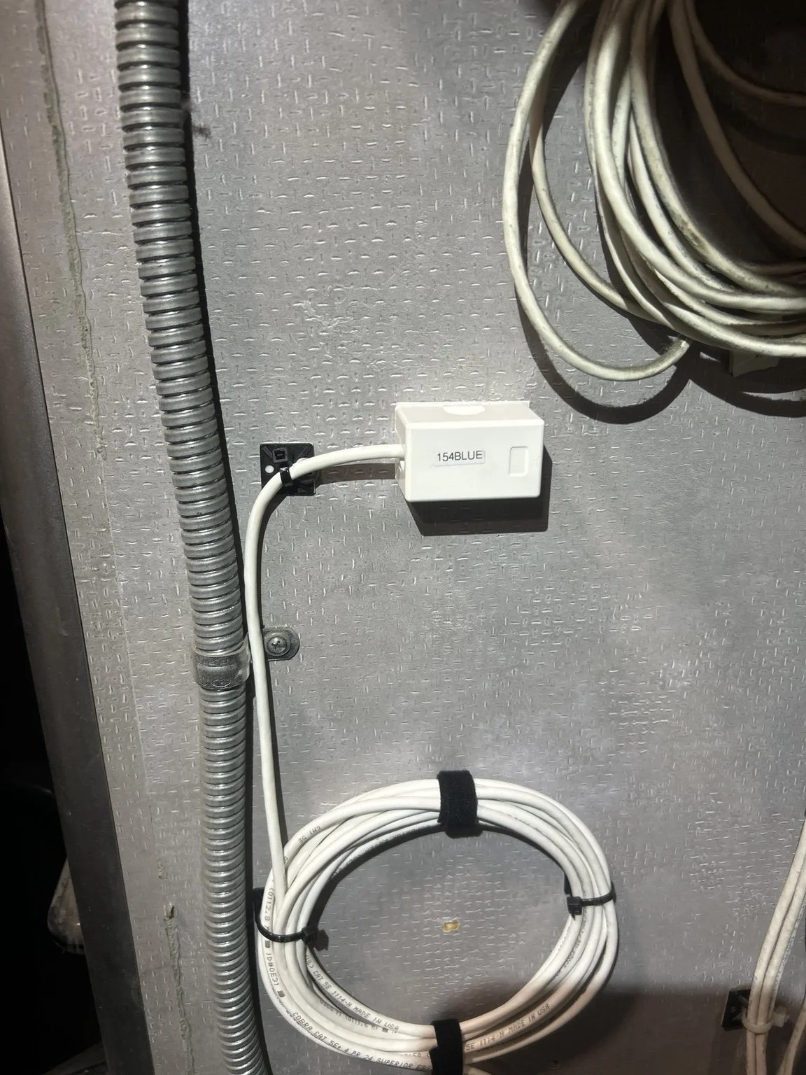 Labeled data outlet and secured cable service loop installed by Porter Communications