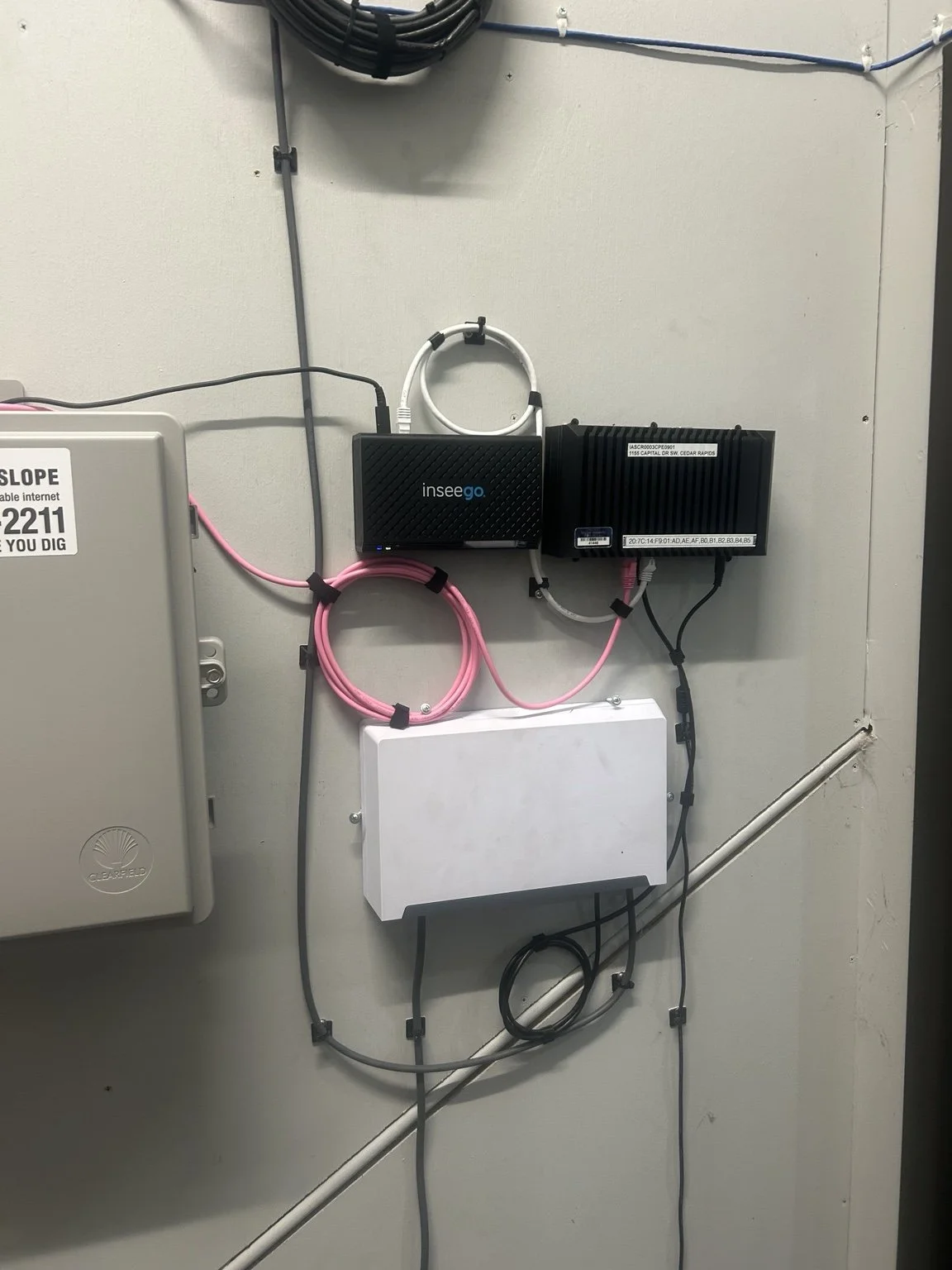 Wall-mounted network equipment with organized cabling and service loops