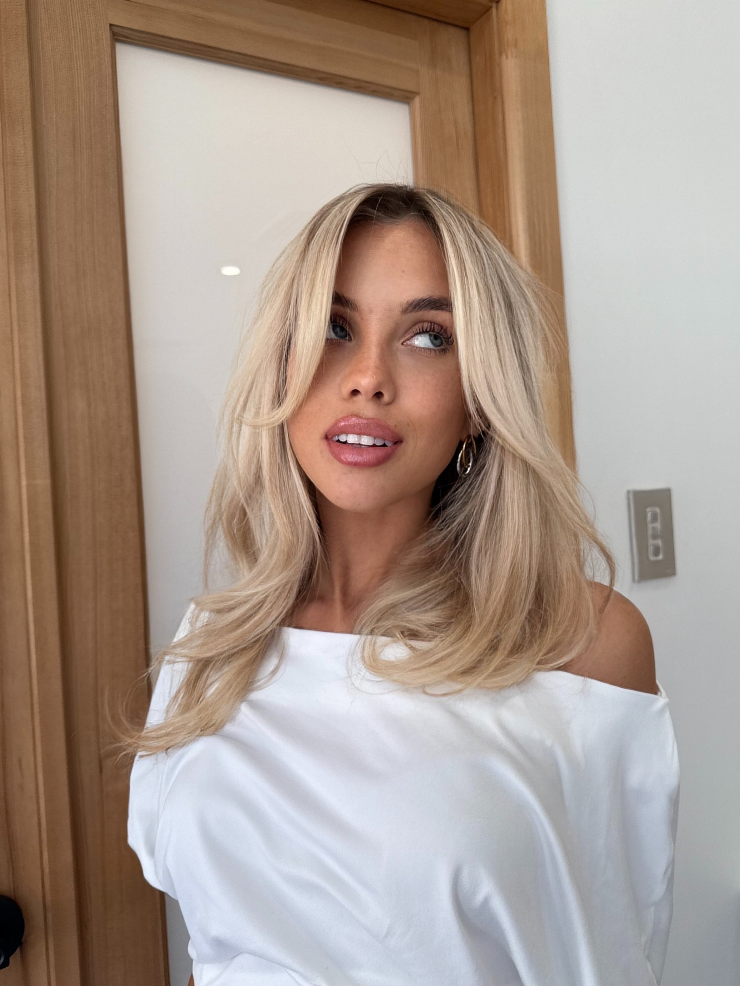 Soft creamy blonde with face-framing layers
