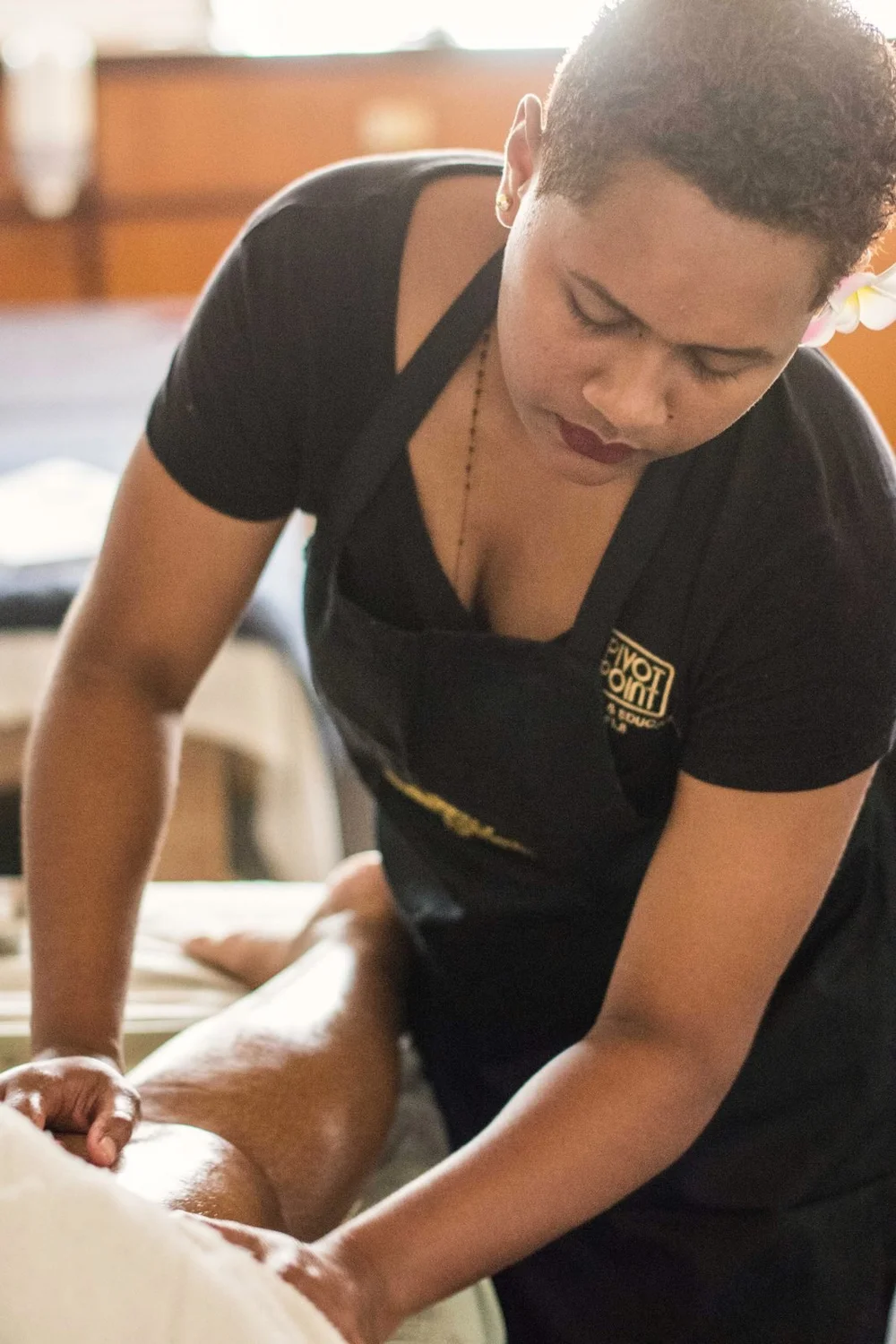 A student colouring a client's hair on the salon floor, 2019