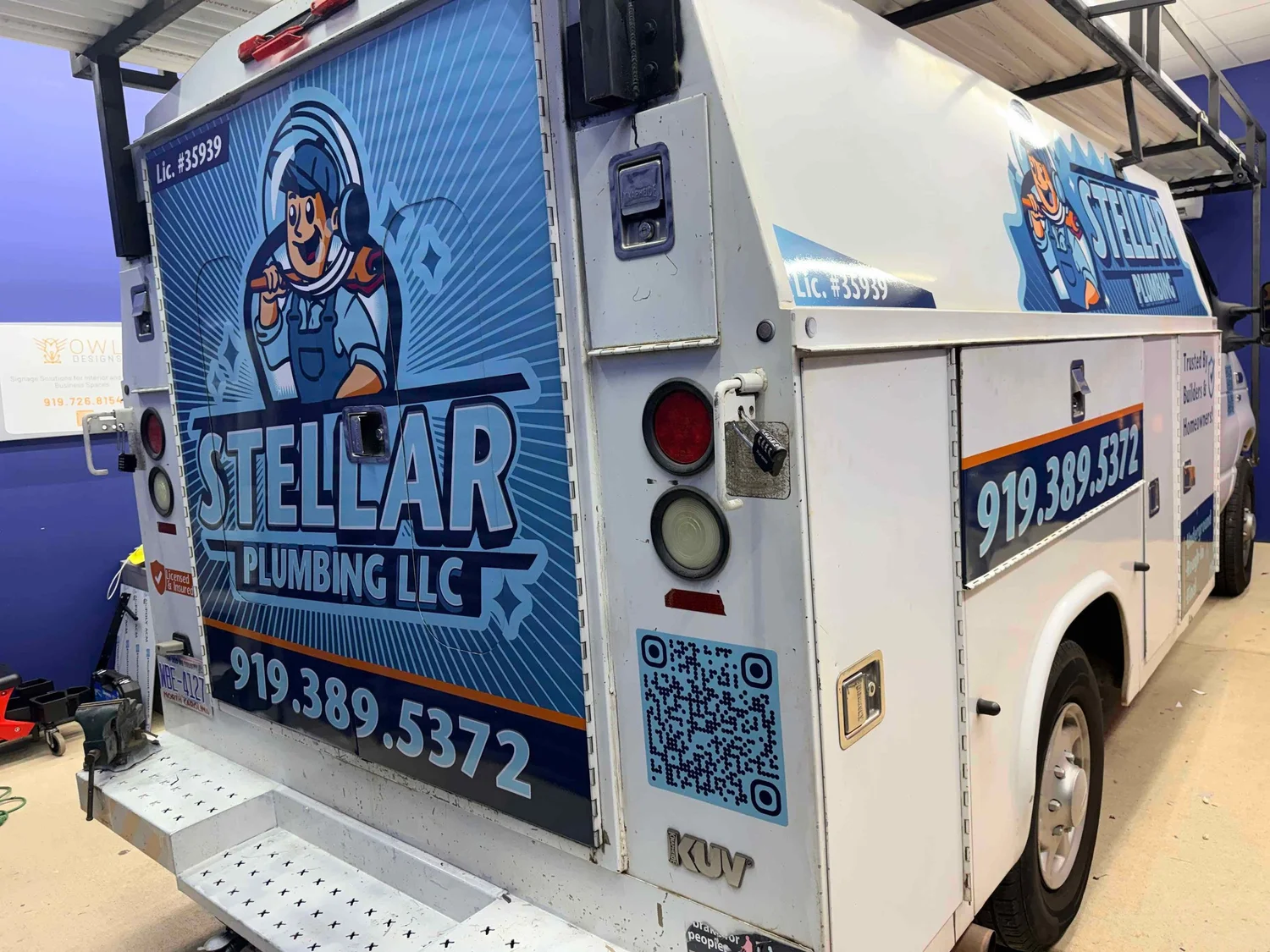 Rear of the wrapped Stellar Plumbing service truck