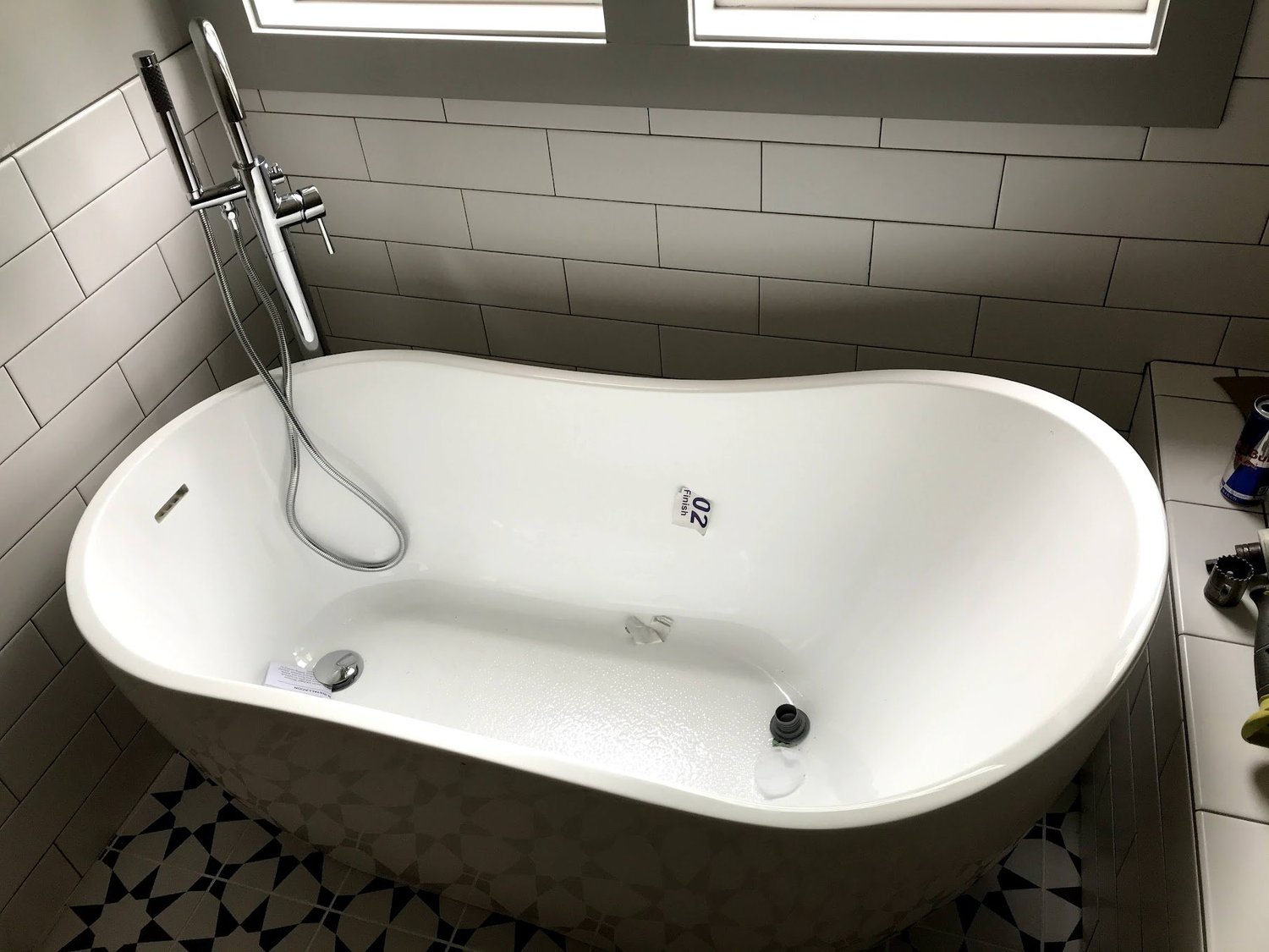 Freestanding soaking tub with floor-mounted tub filler