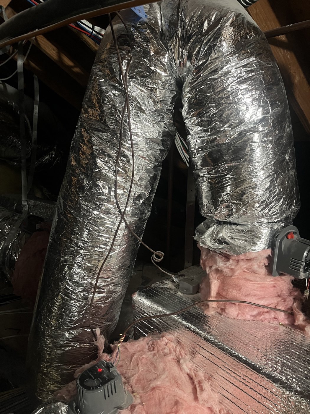 Flex duct kinked at a sharp bend in the attic