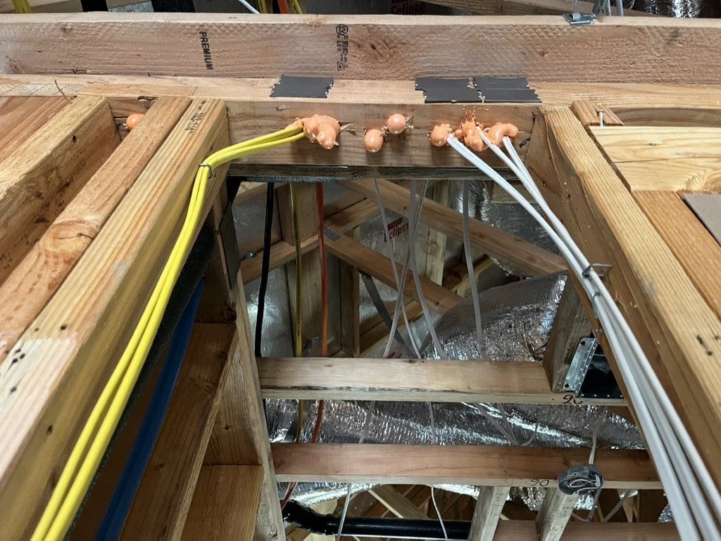 Wire penetrations through the top plate sealed with foam