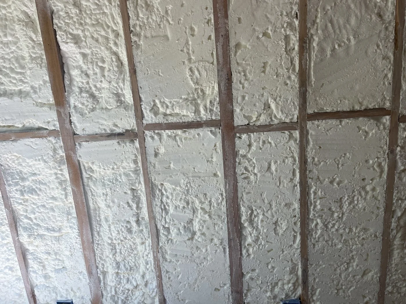 Spray foam filling wall cavities