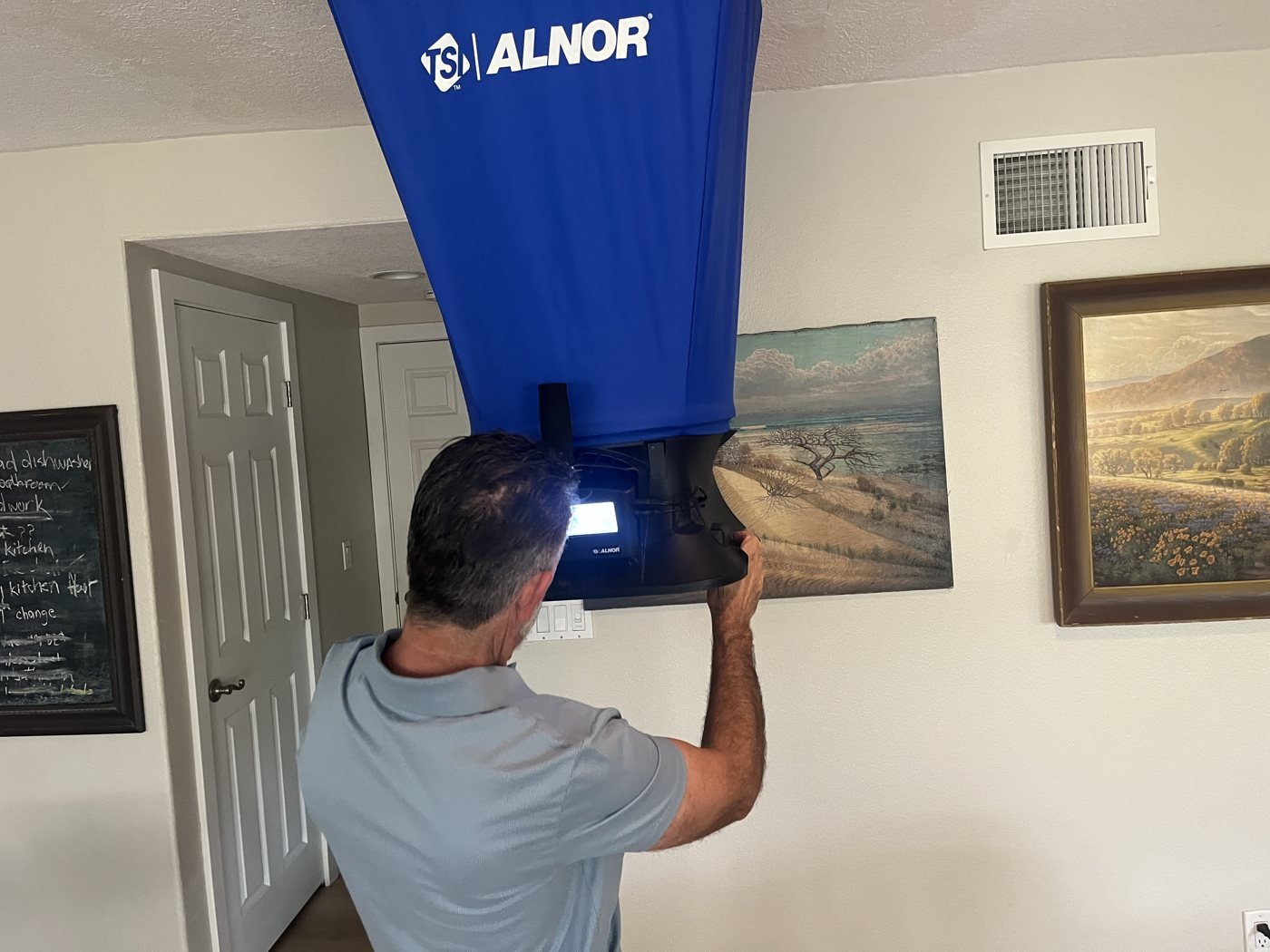 Flow hood sealed over a ceiling return, meter lit