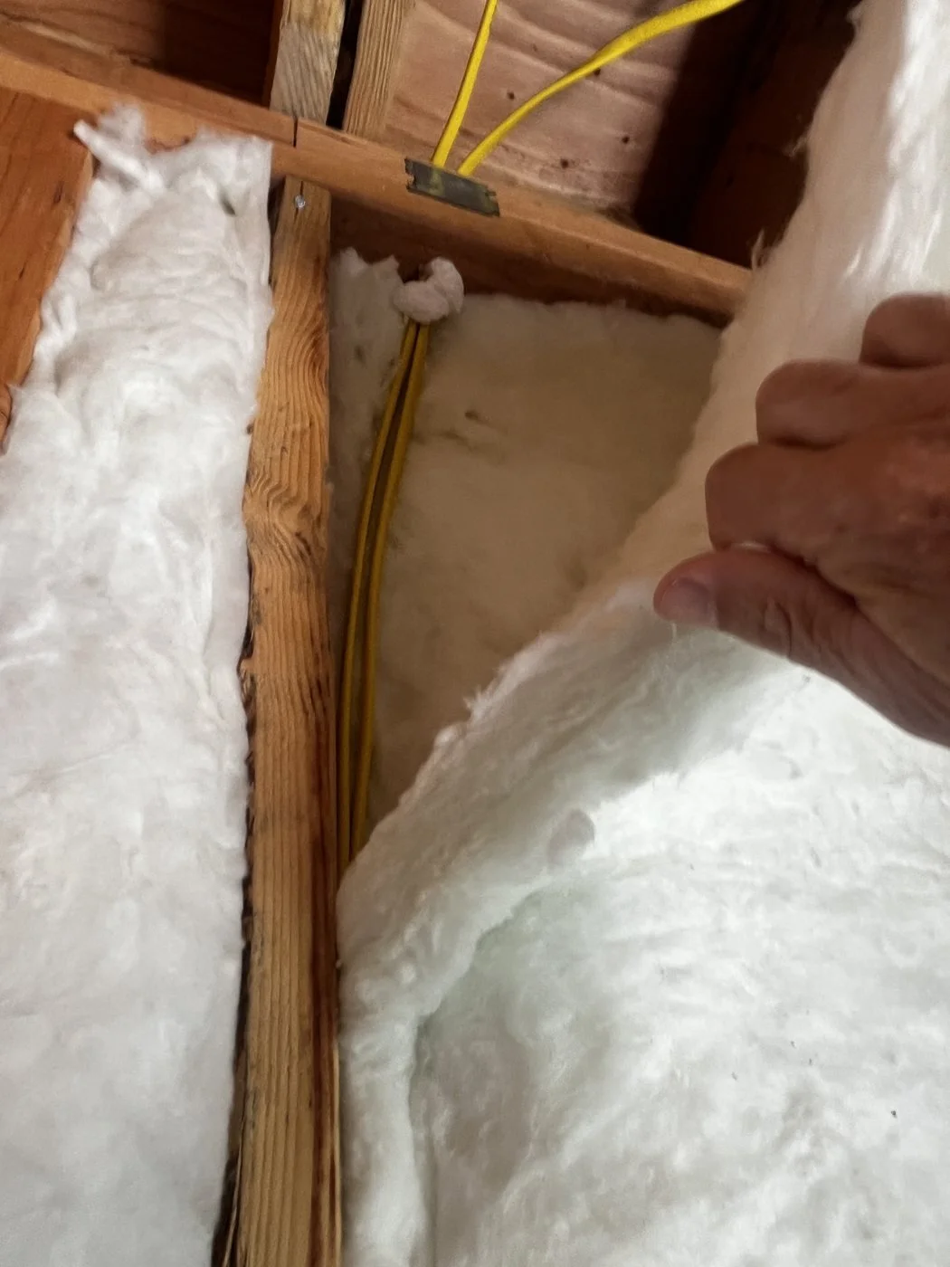 Batt insulation laminated so one layer sits behind the wire and one in front