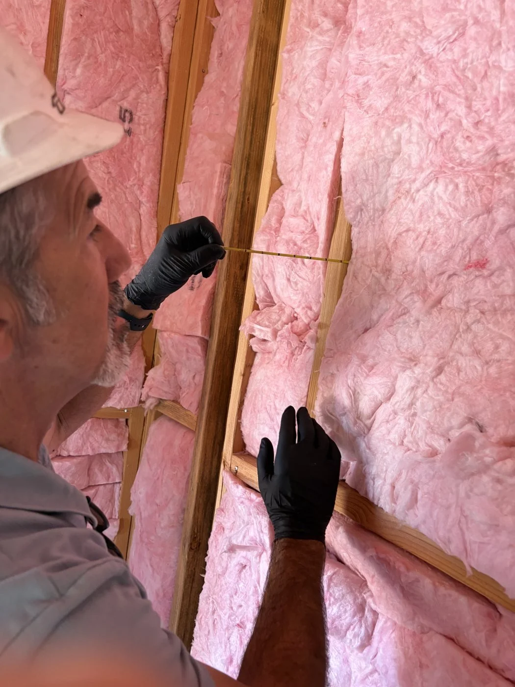 Measuring batt insulation thickness in a wall cavity