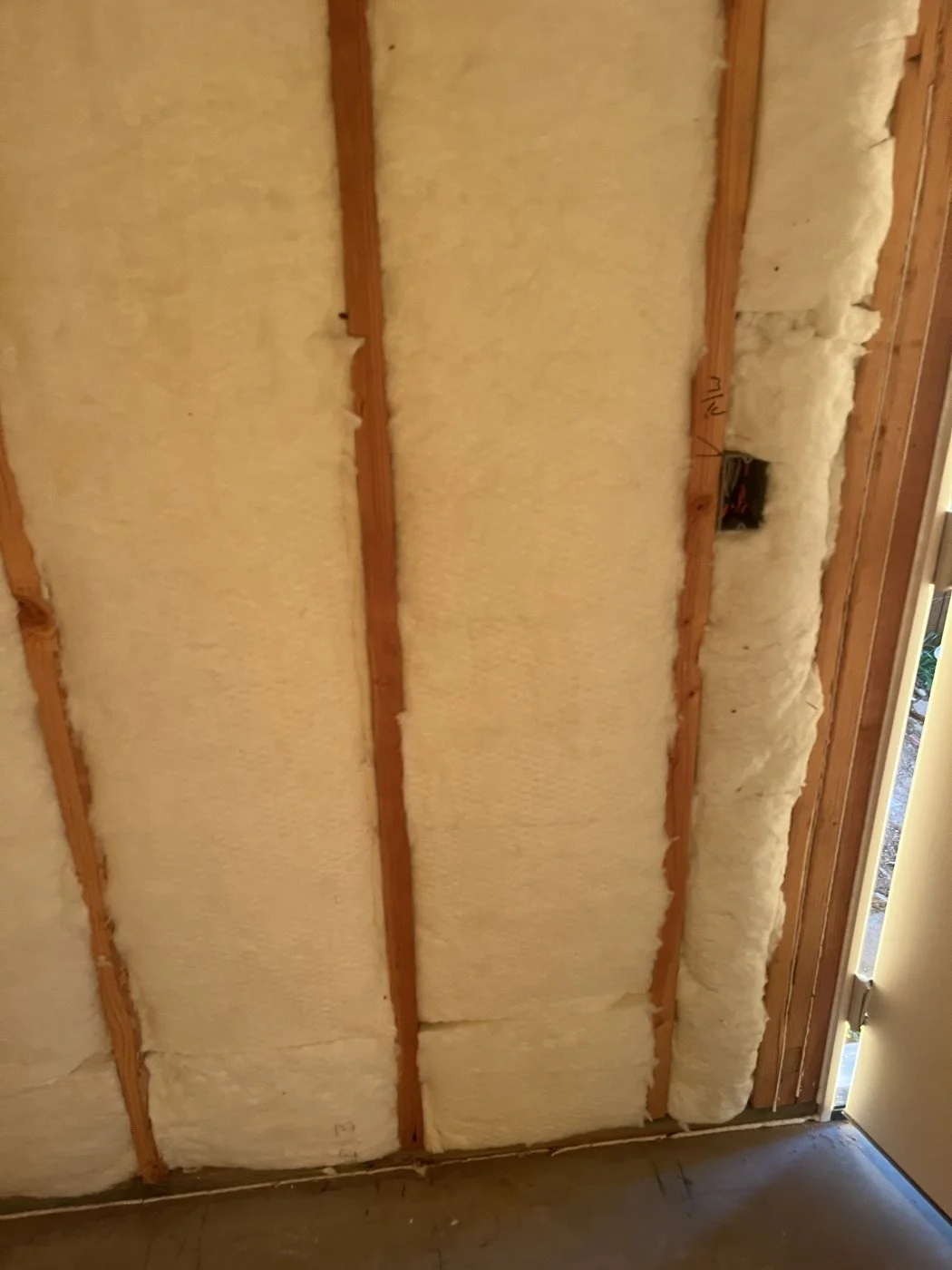 Batts cut to fit around an electrical box