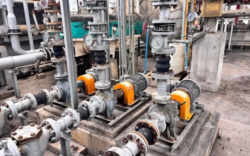 Row of industrial centrifugal pumps with gauges