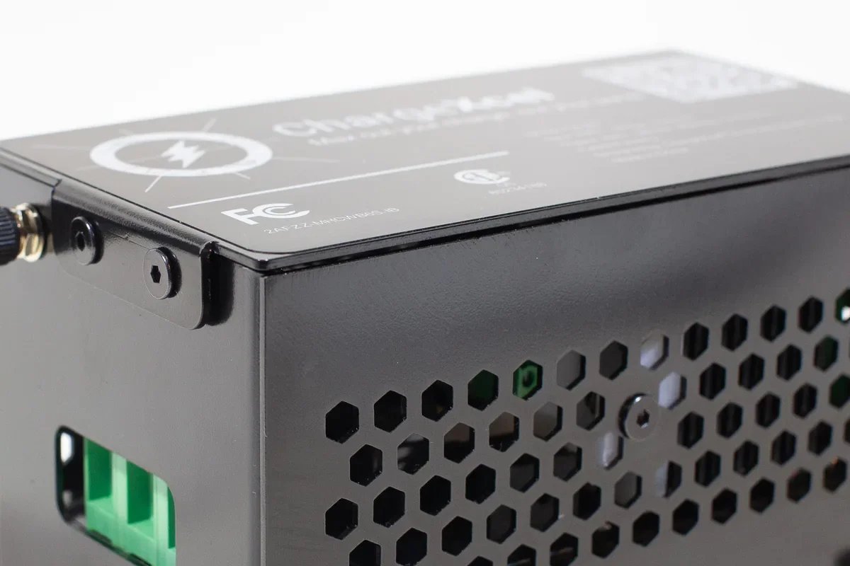 Close-up of the ChargeXcel enclosure corner, antenna connector and green terminal block