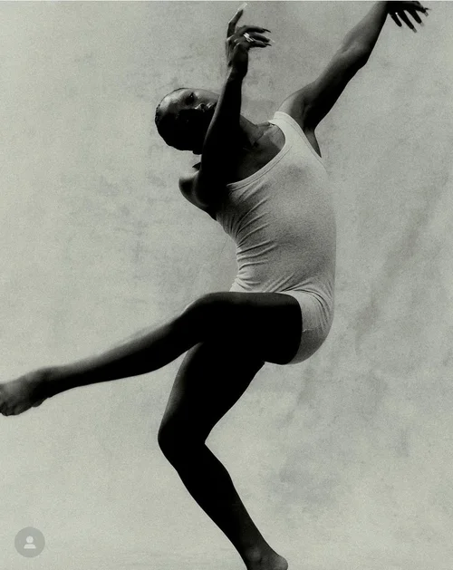 Black-and-white photograph of a dancer mid-leap