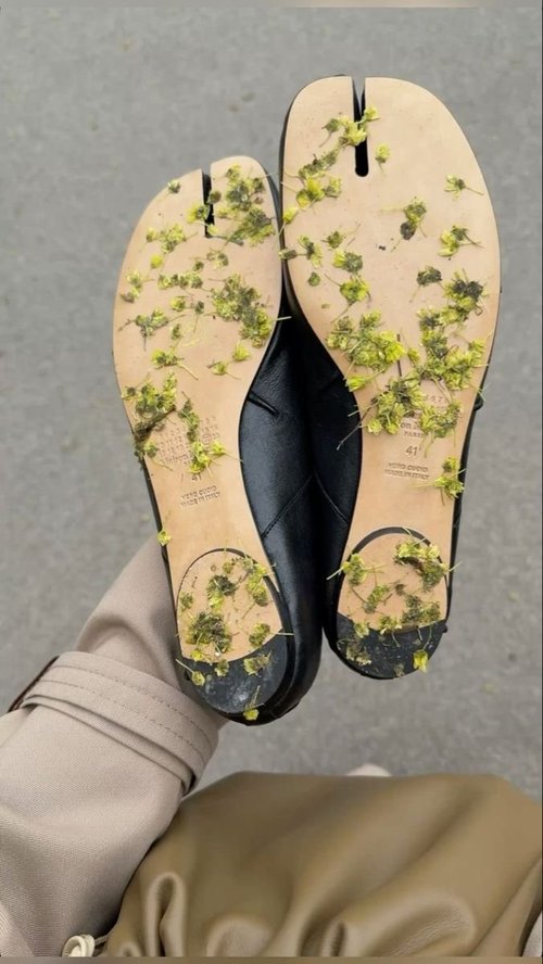 Soles of tabi shoes covered in pressed yellow flowers
