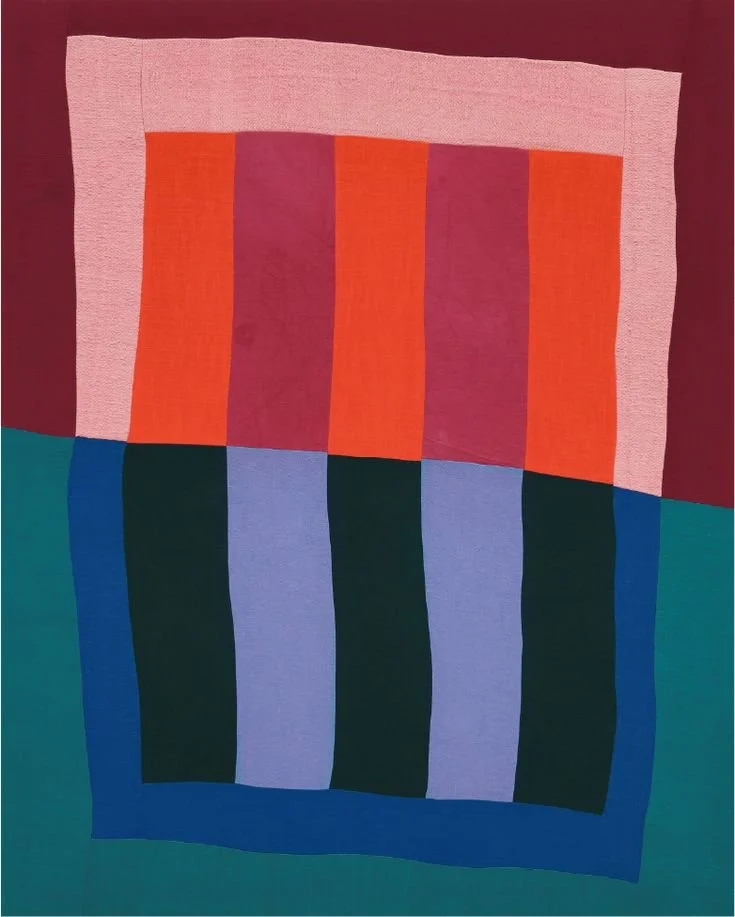 Pieced quilt in coral, plum, cobalt and lavender