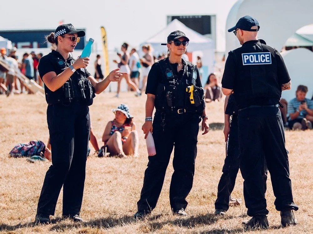 Police officers talking on a festival site on a summer day