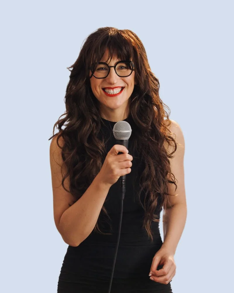 Jennifer in glasses with a microphone on a blue background