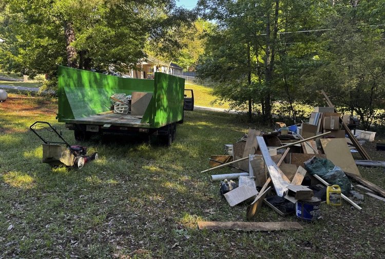 14 yard dumpster with rear door open during a residential cleanout