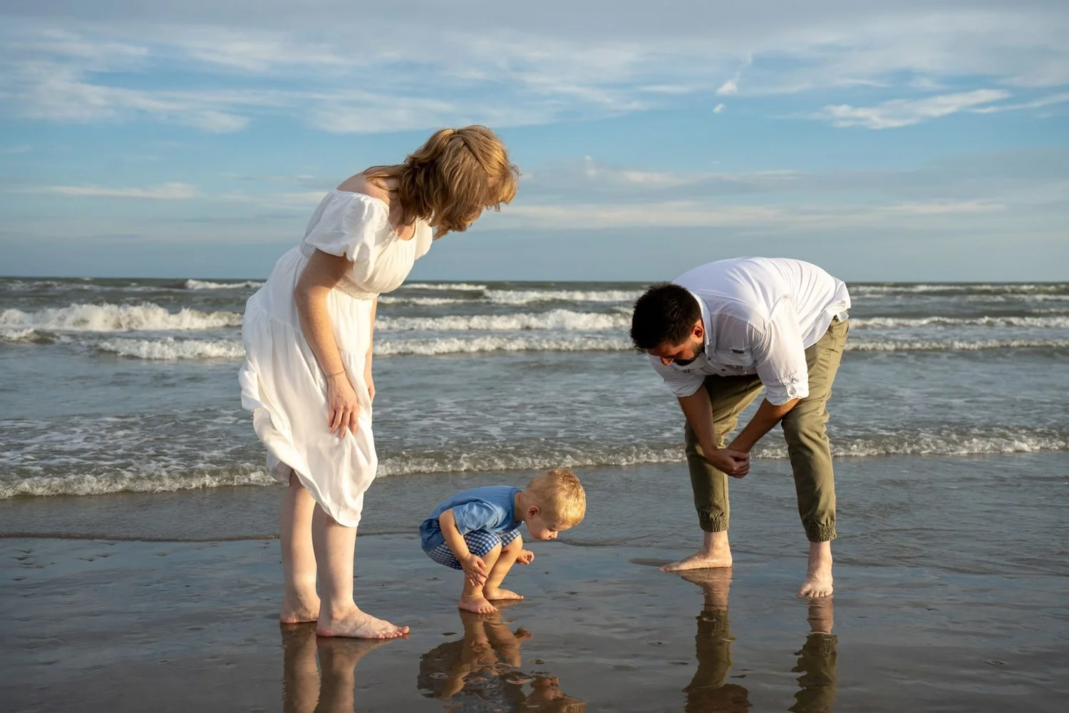 Family walking together on the beach at golden hour