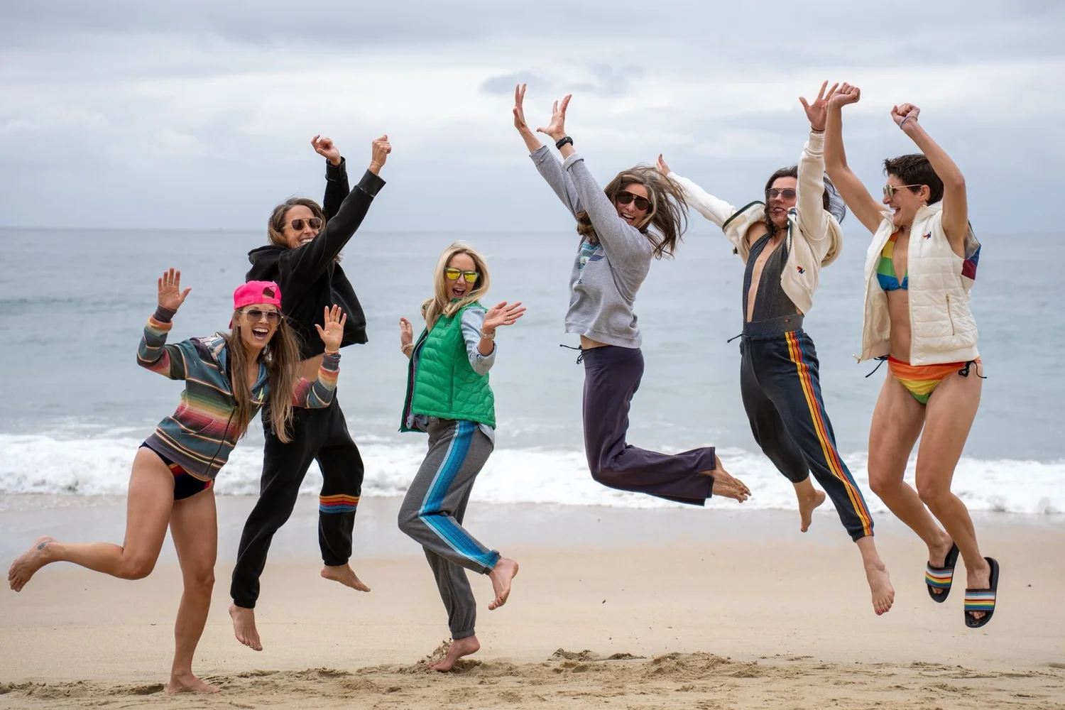 Group of friends jumping on the beach