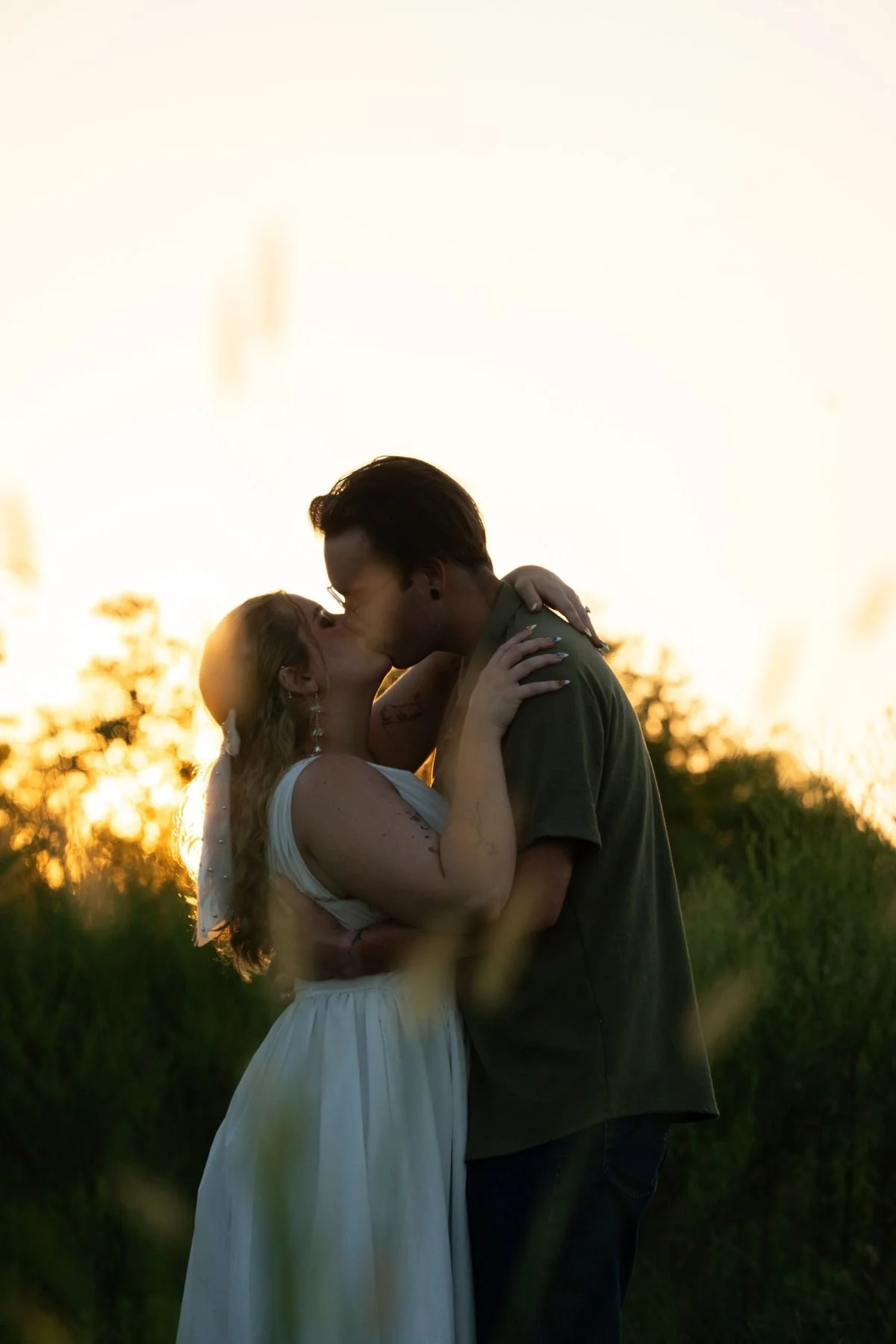 Couple silhouetted against a sunset